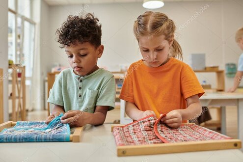 Betreuerin liest einer Kindergruppe aus einem Bilderbuch vor